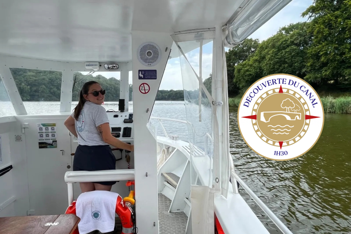 Person steering a boat on a canal, trees in background, with a canal tour logo in corner.